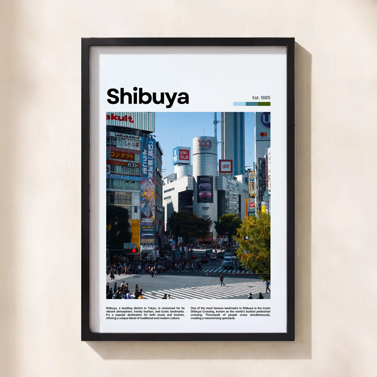 A framed Shibuya cityscape poster print with a black frame, mounted on a light beige wall. The poster features a white header with the text 'Shibuya' and 'Est.