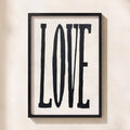Framed artwork with the word 'LOVE' on a light background