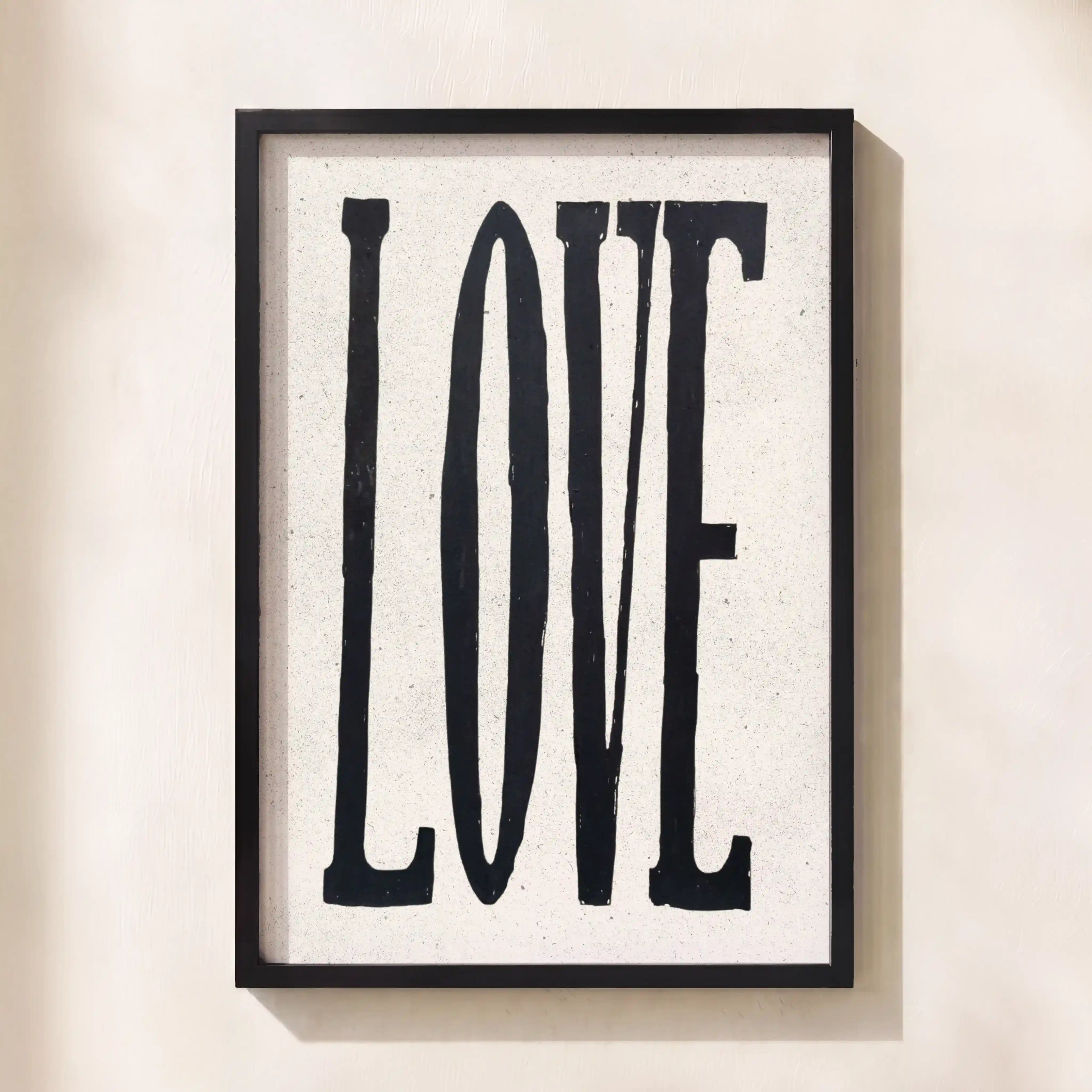 Framed artwork with the word 'LOVE' on a light background