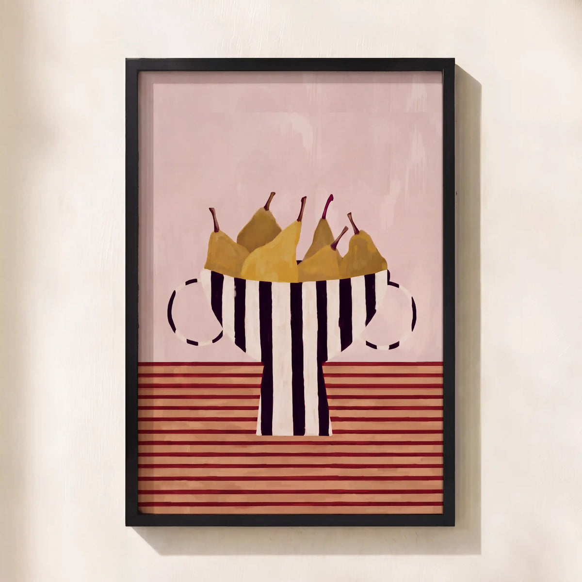 Framed wall art featuring a stylized still life of pears in a striped bowl, hung on a light beige wall.