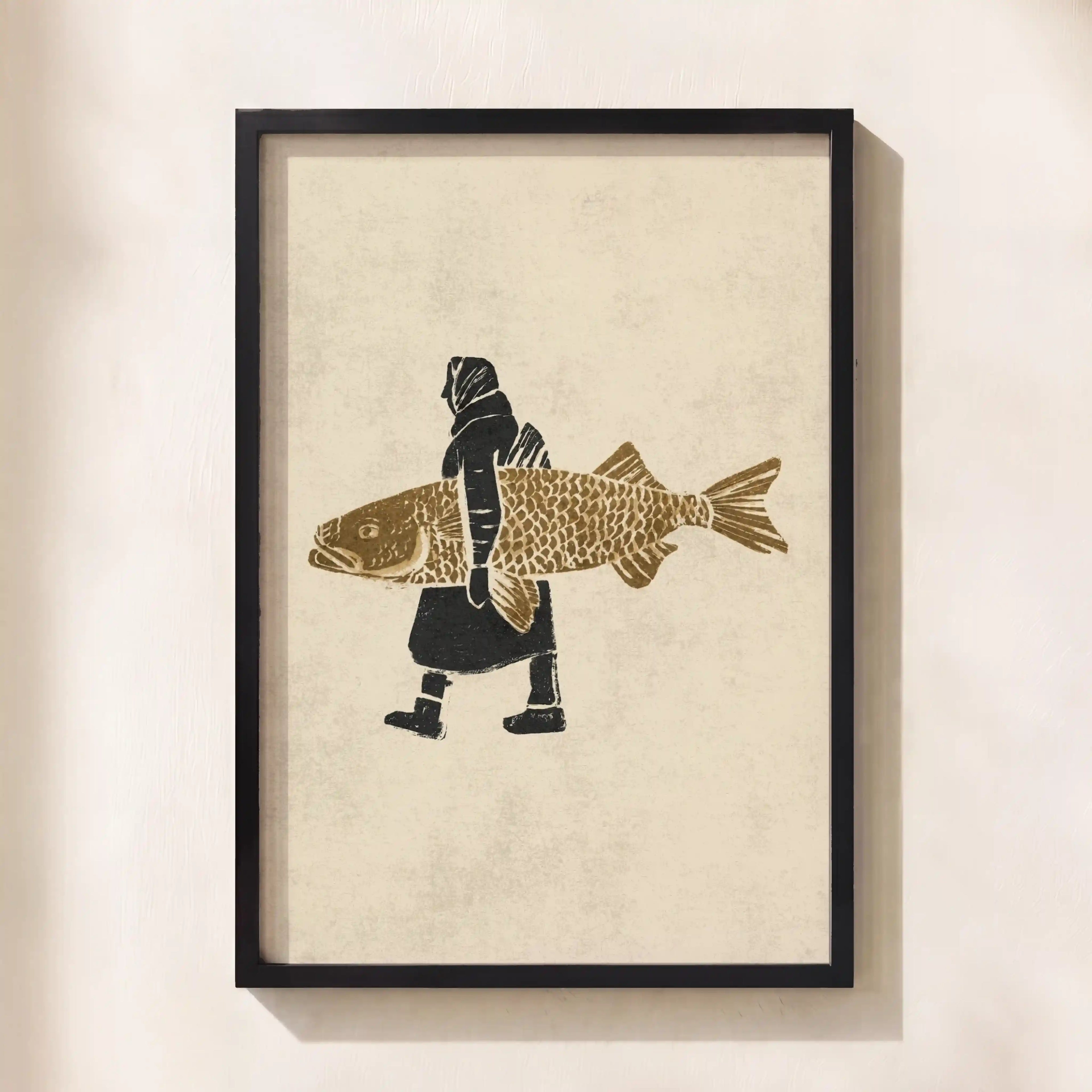 Framed wall art featuring a minimalist illustration of a person carrying a large fish, shown hanging on a light beige wall.