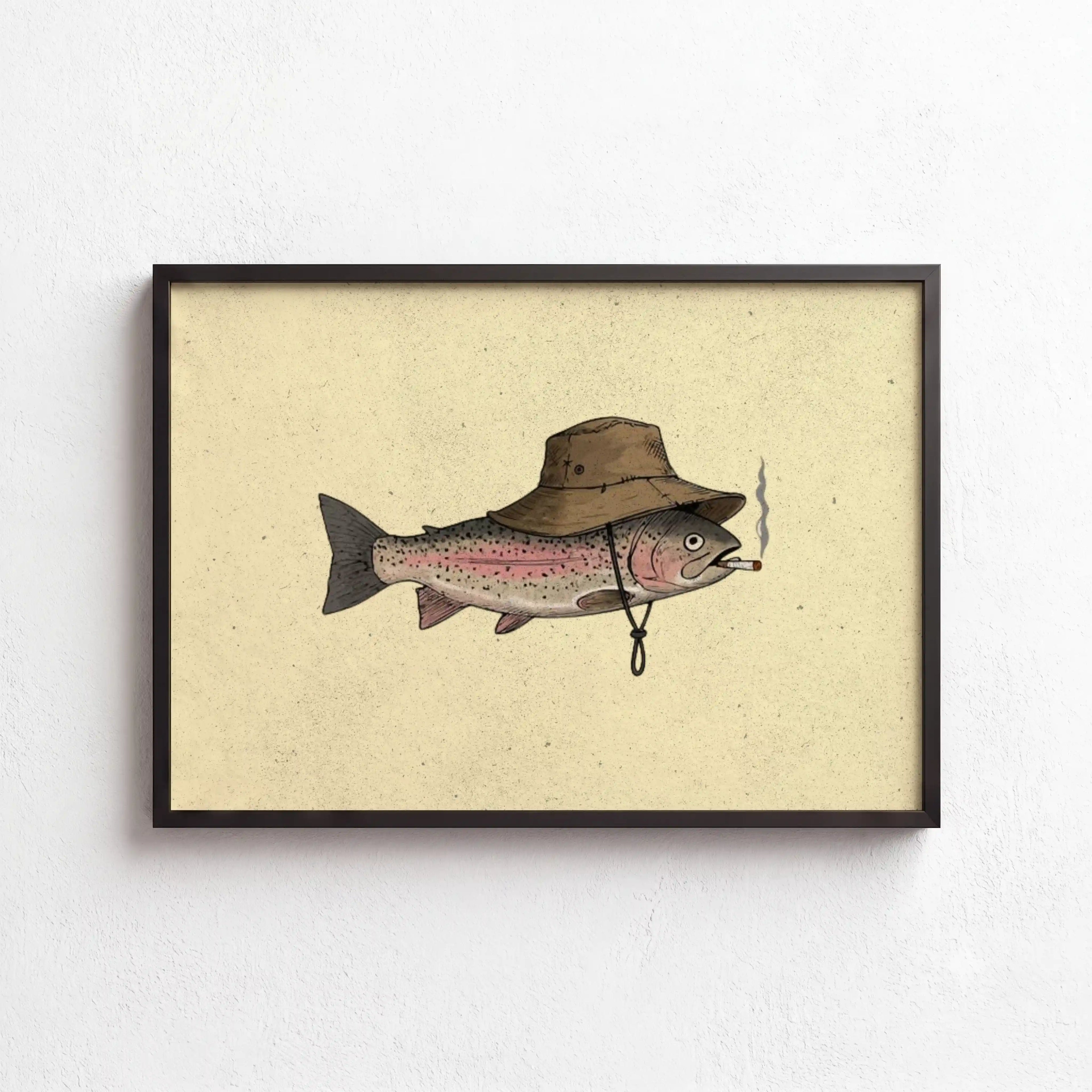 Framed wall art featuring a whimsical illustration of a pink and silver fish wearing a brown wide-brim hat and smoking a cigarette, set against a textured cream background with a black frame.