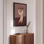 Wooden sideboard against a wall with a framed artwork above it.