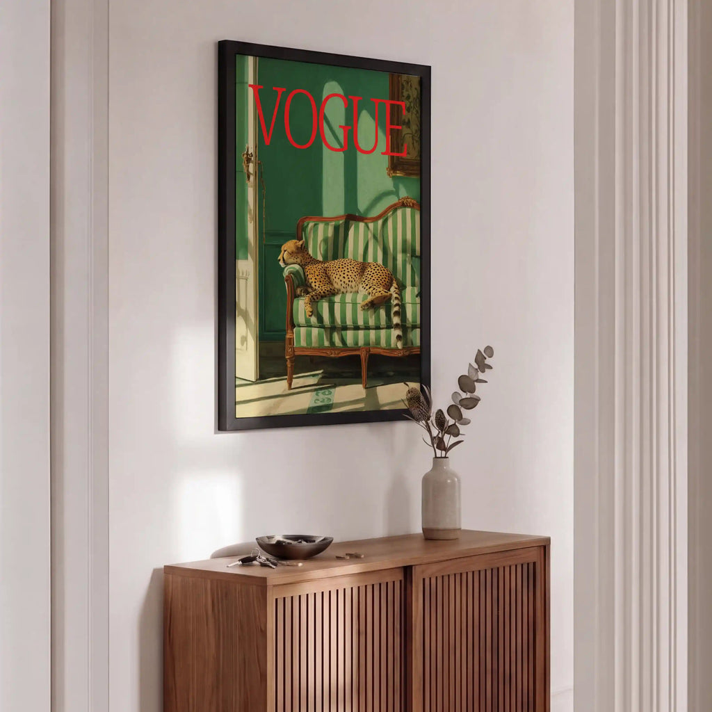Framed Vogue magazine cover above a wooden sideboard with decorative items.