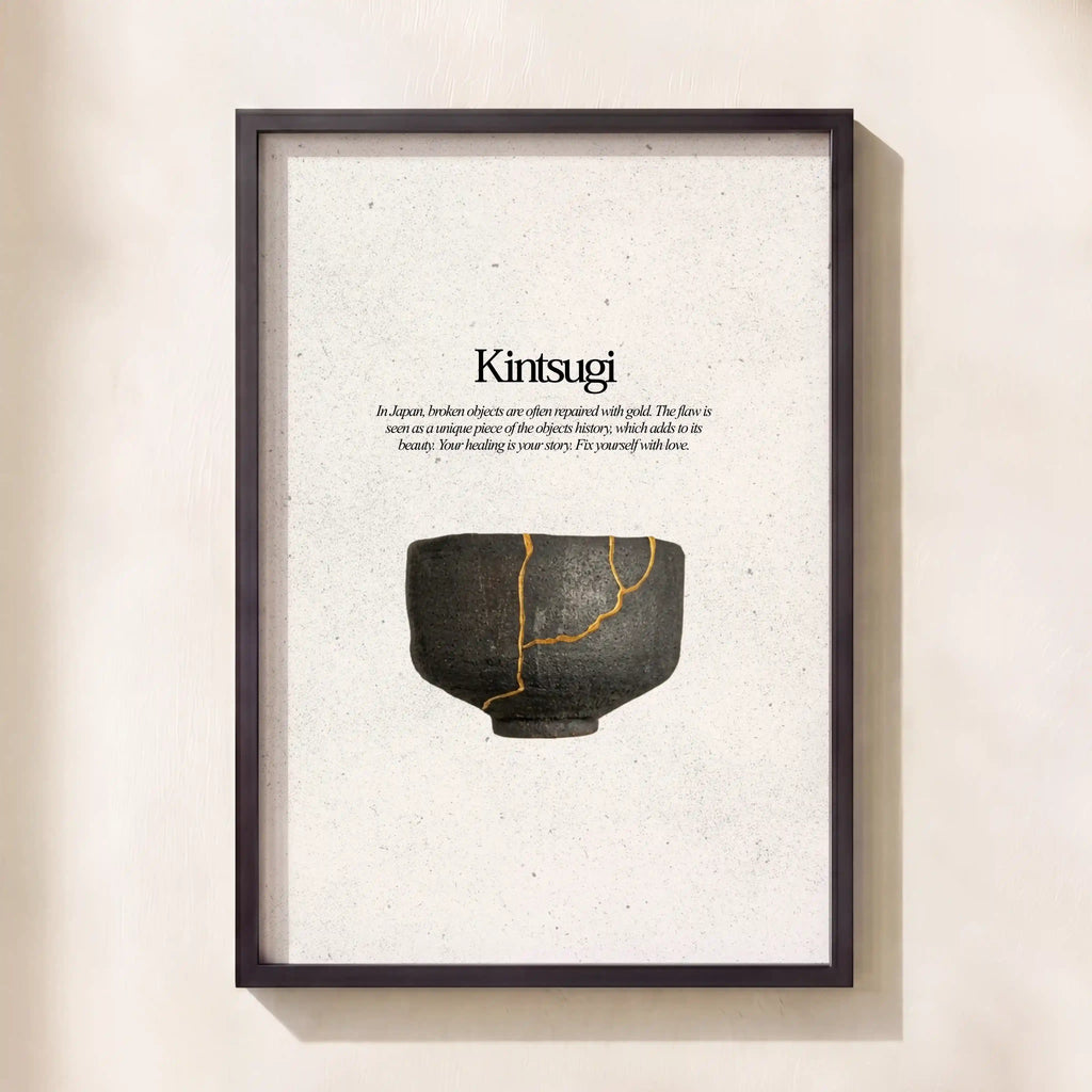 Framed artwork with a black and gold ceramic bowl and 'Kintsugi' text on a beige background