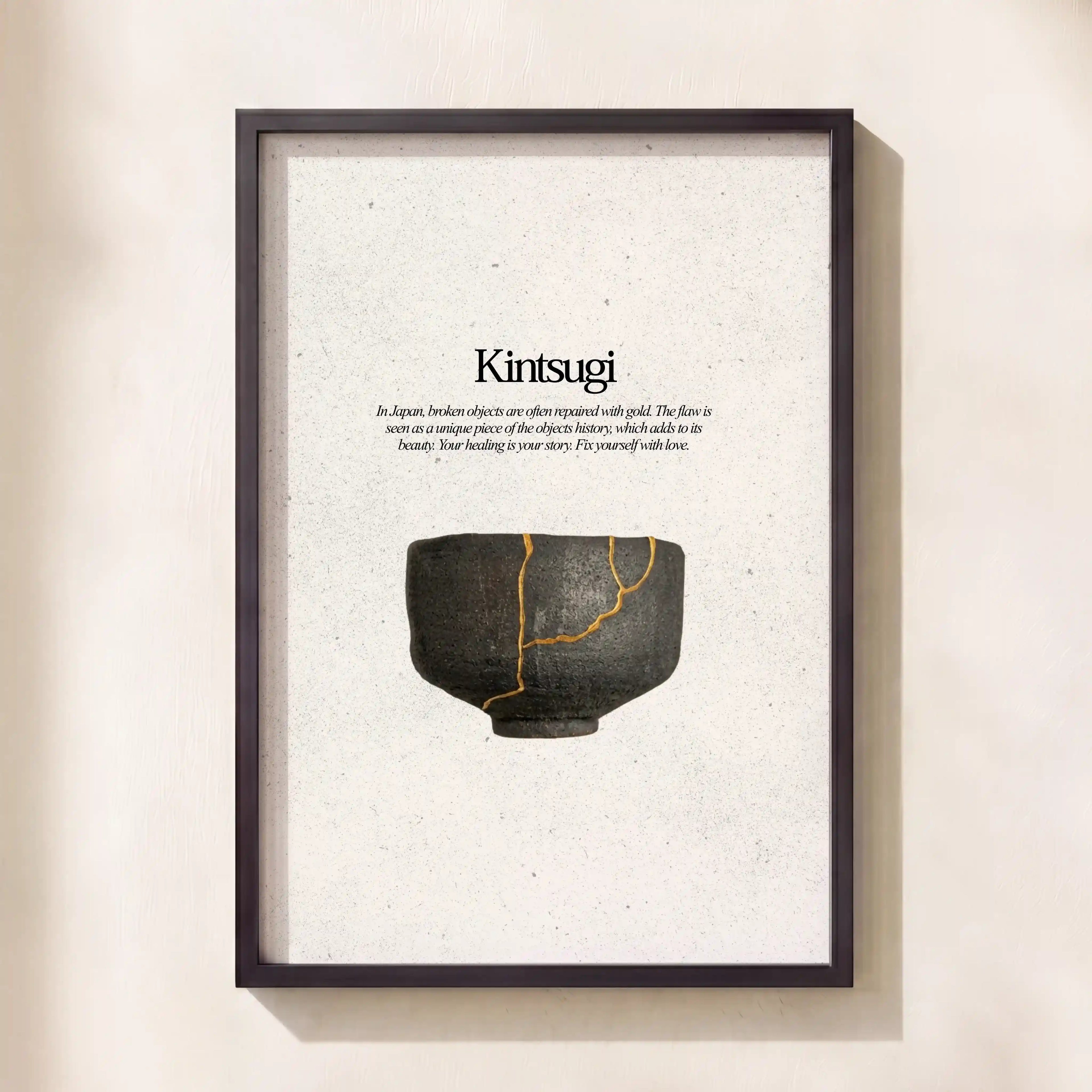 Framed artwork with a black and gold ceramic bowl and 'Kintsugi' text on a beige background