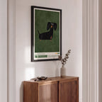 Wooden cabinet with a framed poster of a dachshund on a wall.