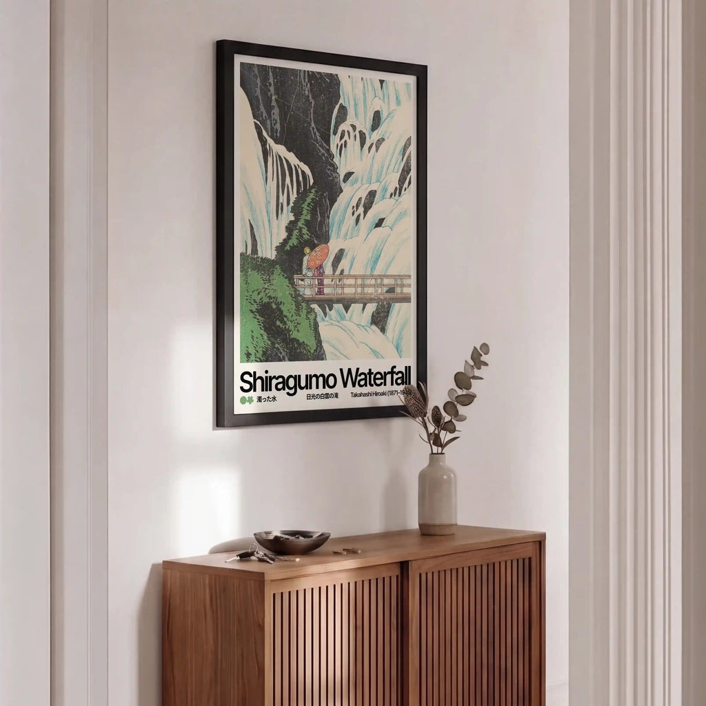 Wooden sideboard with a framed poster of Shiragumo Waterfall on a wall.